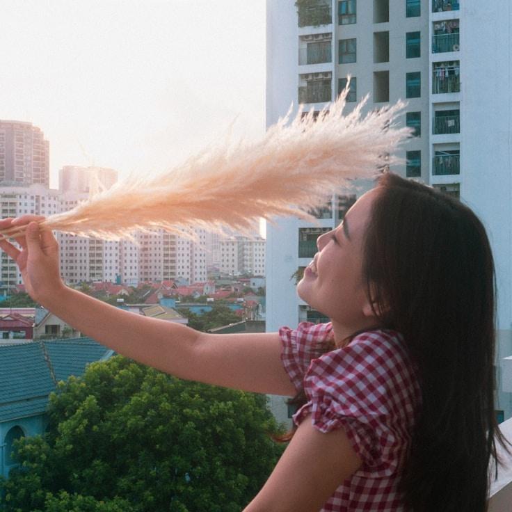 Alex Chen, Lead Design Curator at Distant Mountain View, reviewing corporate floral arrangements